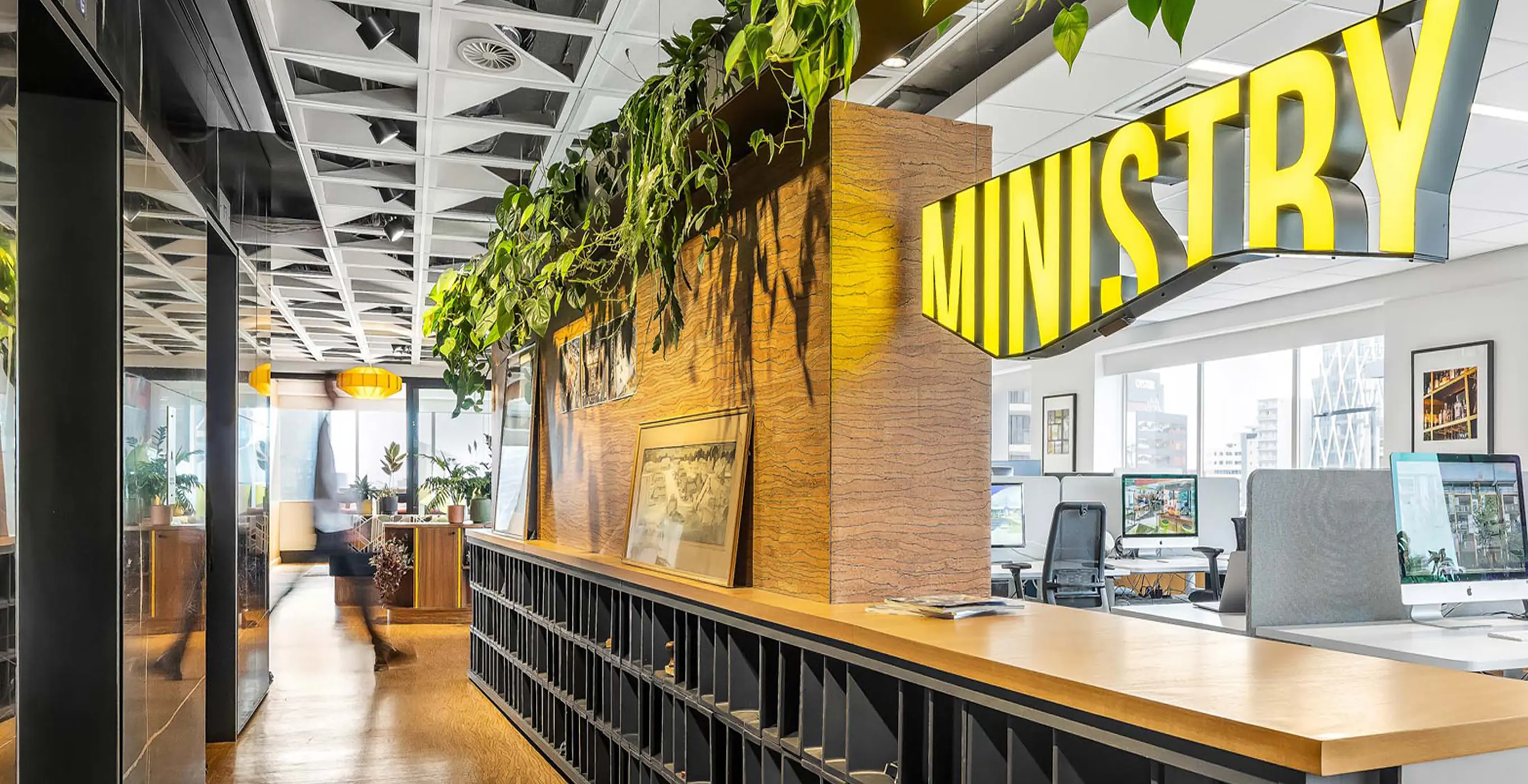 Ministry studio interior with a yellow MINISTRY sign above a long timber and black shelving unit