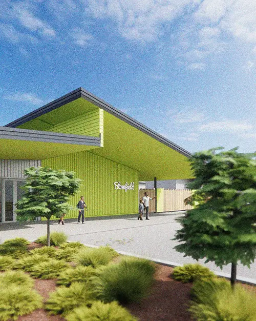 Render of a community building with a bright green facade and angled roof, framed by new landscaping
