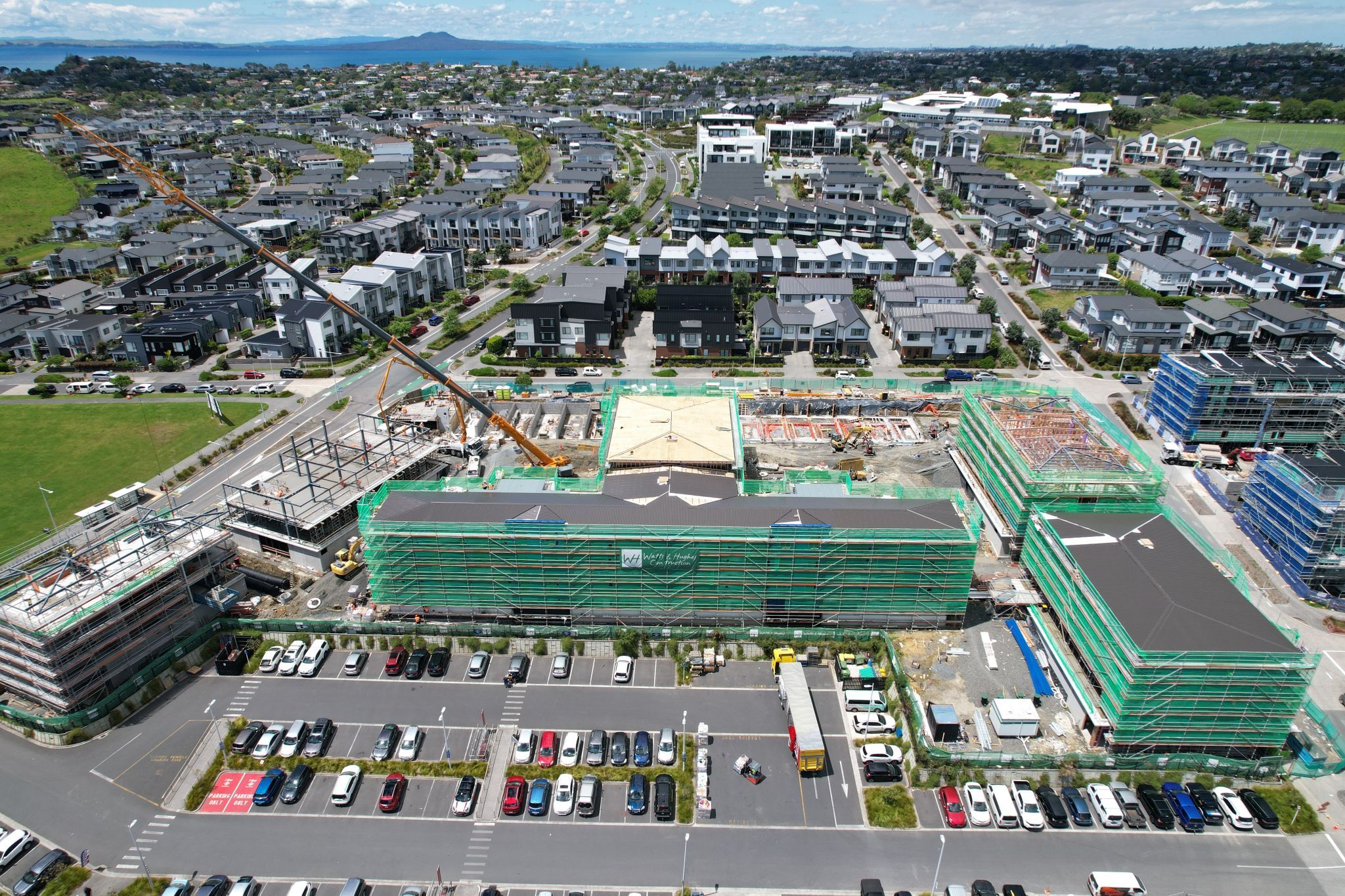 Aerial view of a construction site under scaffolding within a new suburban neighbourhood