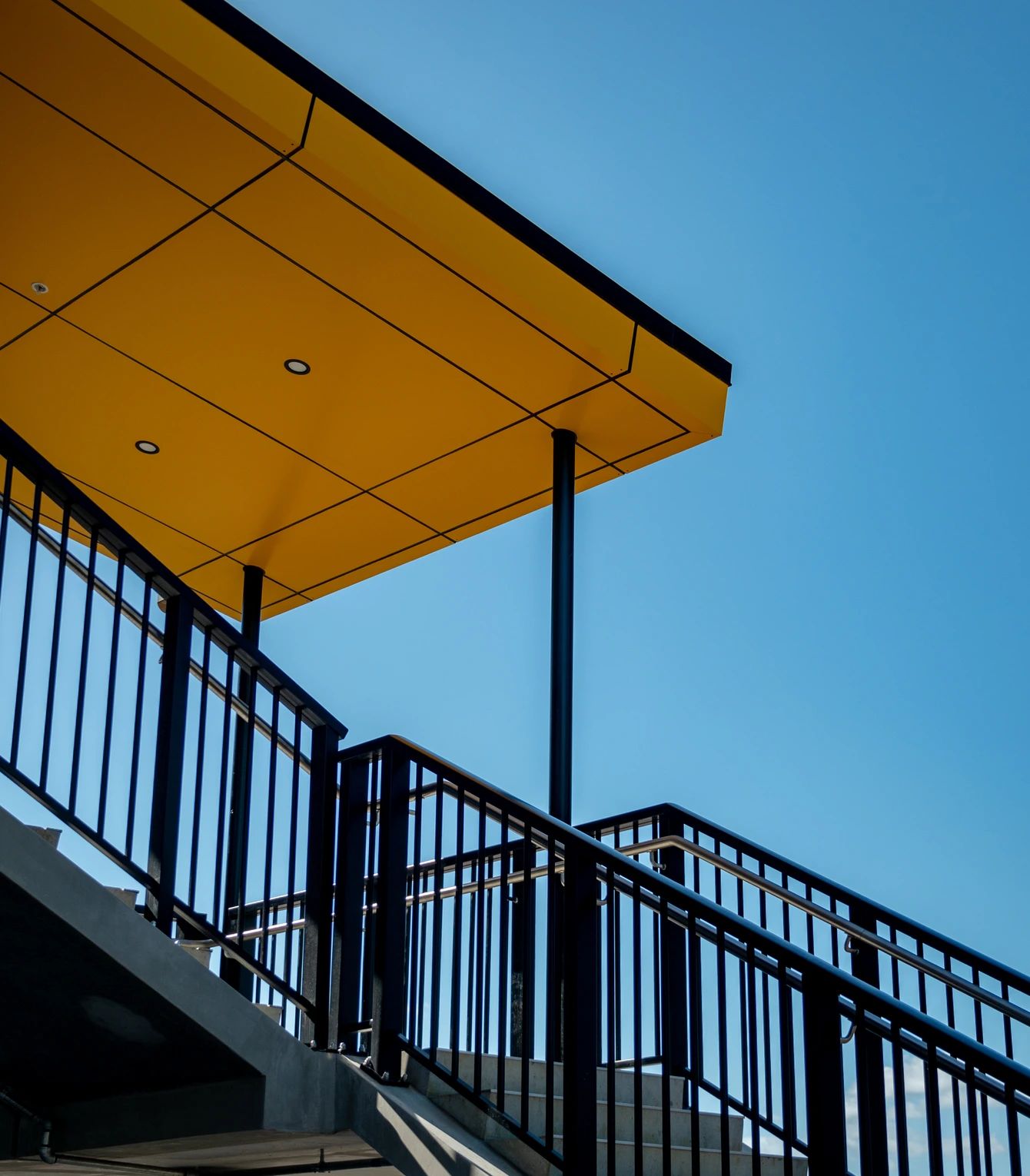 Yellow canopy over an external stair and balustrade at St Thomas's School